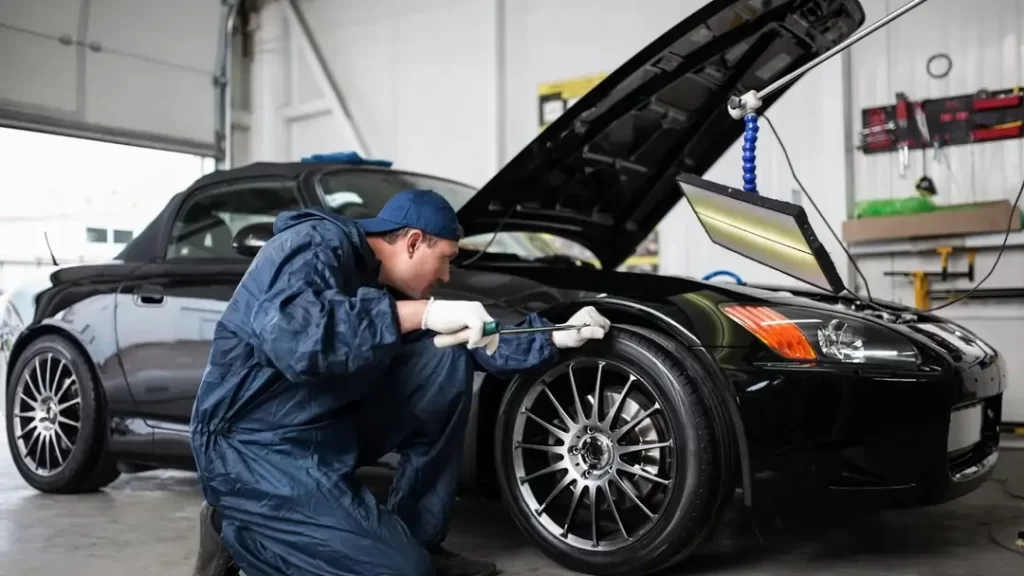 Technician explaining repair process to a customer while choosing auto body shop services
